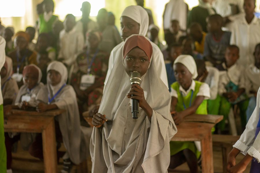 A student speaking into a microphone during a FirstPage Foundation programme